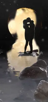 Silhouette of couple under moonlight on rocks.