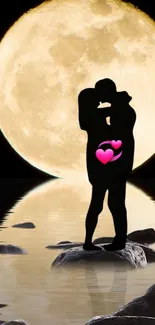 Silhouette of a couple kissing in front of a full moon reflection on water.