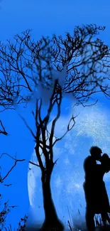 Romantic silhouette of a couple kissing under a tree in blue moonlight.