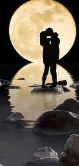 Silhouetted couple embraces under full moon with water reflections and rocks.