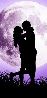 Silhouette of lovers embracing under a purple moonlit sky.