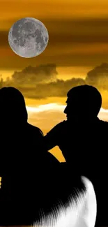 Couple silhouette with a full moon in an orange sunset sky.