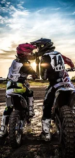 Two motorbike riders kissing at sunset.