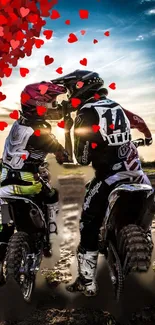 Motocross couple embracing with hearts under a sunset sky.