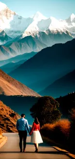 Couple walking on road with snow-capped mountains