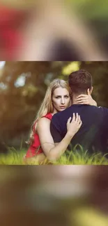 Couple embracing in a lush green outdoor setting with natural lighting.