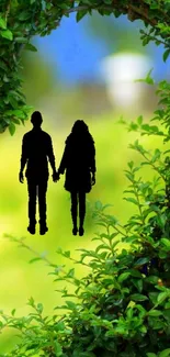 Silhouette of couple with green foliage and blue sky background.