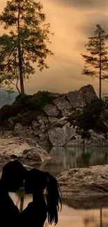 Romantic silhouette of couple by a serene lake with trees and stormy sky.