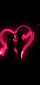 Silhouette of a couple with a pink neon heart glowing behind them.