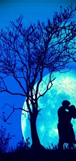 Silhouette of couple kissing under glowing turquoise moon.