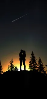 Silhouette of couple kissing under meteor in starry night sky with trees.