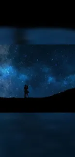 Romantic couple silhouetted against a starry night sky.