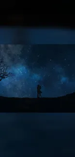 Silhouetted couple embracing under a starry night sky with a barren tree on the side.