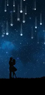 A silhouette of a couple under a starry dark blue night sky.