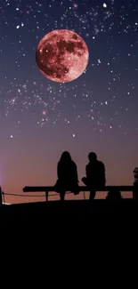 Silhouetted couple under a red moon with starry night sky.