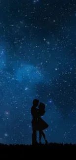 Silhouette of a couple embracing under a starry night sky.