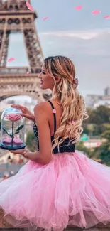 Girl in pink tulle dress by Eiffel Tower in Paris.