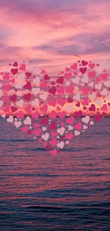 Romantic pink heart on ocean sunset background wallpaper.