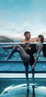 Couple beside pool with mountains and blue sky.