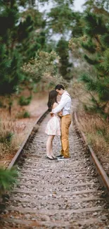 Romantic couple embracing on a forest railway track.