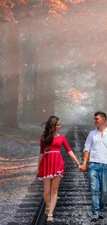 A couple walking on railway tracks in a romantic forest setting with autumn leaves.