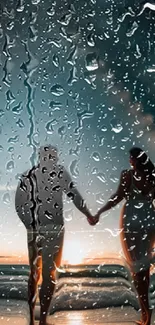 Couple holding hands in rain at sunset beach.