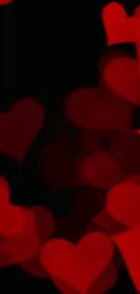 Romantic wallpaper with red hearts on black background.