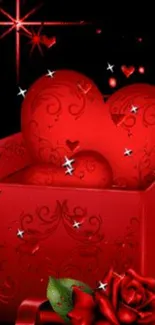 A red heart inside a gift box with roses and stars on a black background.