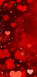 Romantic red heart wallpaper with glowing bokeh and sparkles.