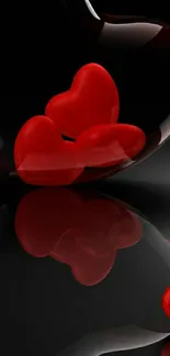 Red hearts reflected on glossy black surface.