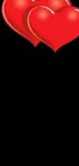 Red hearts with a black background wallpaper.