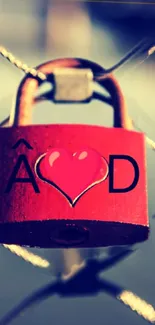 Red love lock on a fence with heart design.