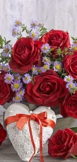 Romantic bouquet of red roses and flowers in heart vase.