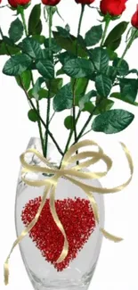 Bouquet of red roses in a heart-decorated vase with golden ribbon.