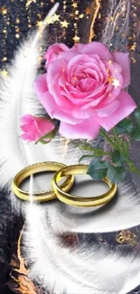 Pink rose with golden rings on feather background.