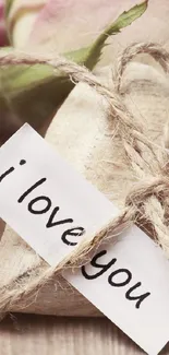 Rustic heart with 'I love you' note and pink roses.