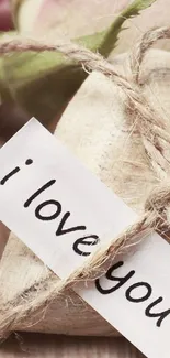 Romantic rustic wallpaper with 'I love you' message on a heart.