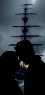 Silhouette of couple with ship under stormy sky.