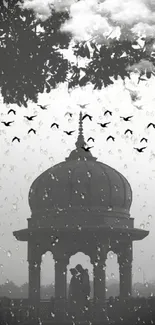 Romantic silhouette under gazebo at sunset with birds and raindrop effect.