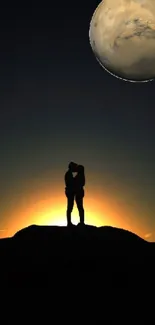 Silhouette couples at sunset with planet backdrop