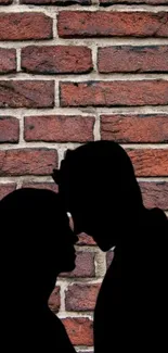 Romantic couple silhouette on a brick wall wallpaper.