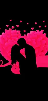 Silhouette couple in front of a pink heart.