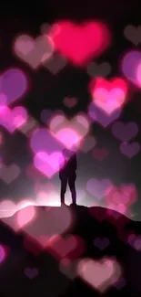 Romantic silhouette of a couple embracing on a mountain top.