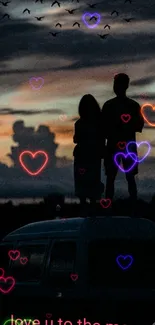 Silhouette of a couple with neon hearts against a twilight sky.