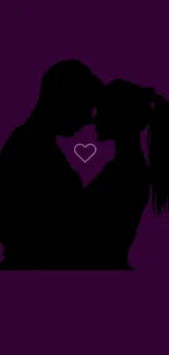 Silhouette of a romantic couple with heart on a purple background.