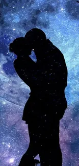 Silhouette of a couple kissing under a galaxy-inspired night sky with stars.