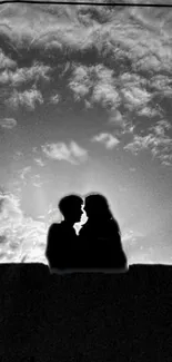 Romantic silhouette of a couple kissing at sunset.