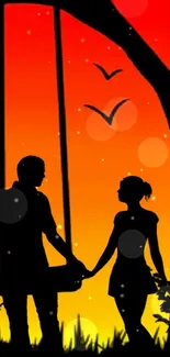 Silhouette of a couple at sunset with vivid orange and red hues.