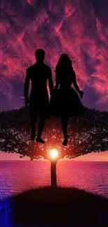 Silhouette of a couple under a vibrant sunset sky with a tree, over an ocean view.