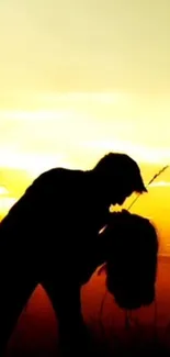 Silhouetted couple kissing in a sunset scene.